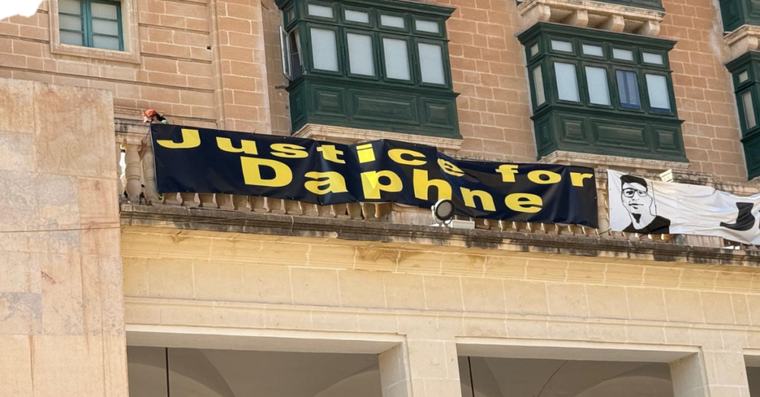 Watch: ‘Justice For Daphne’ Poster Goes Up Outside Parliament